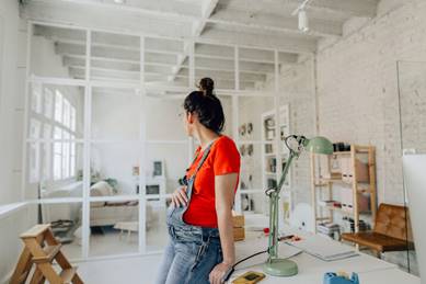 Pregnant woman sitting in office - Pregnancy Discrimination